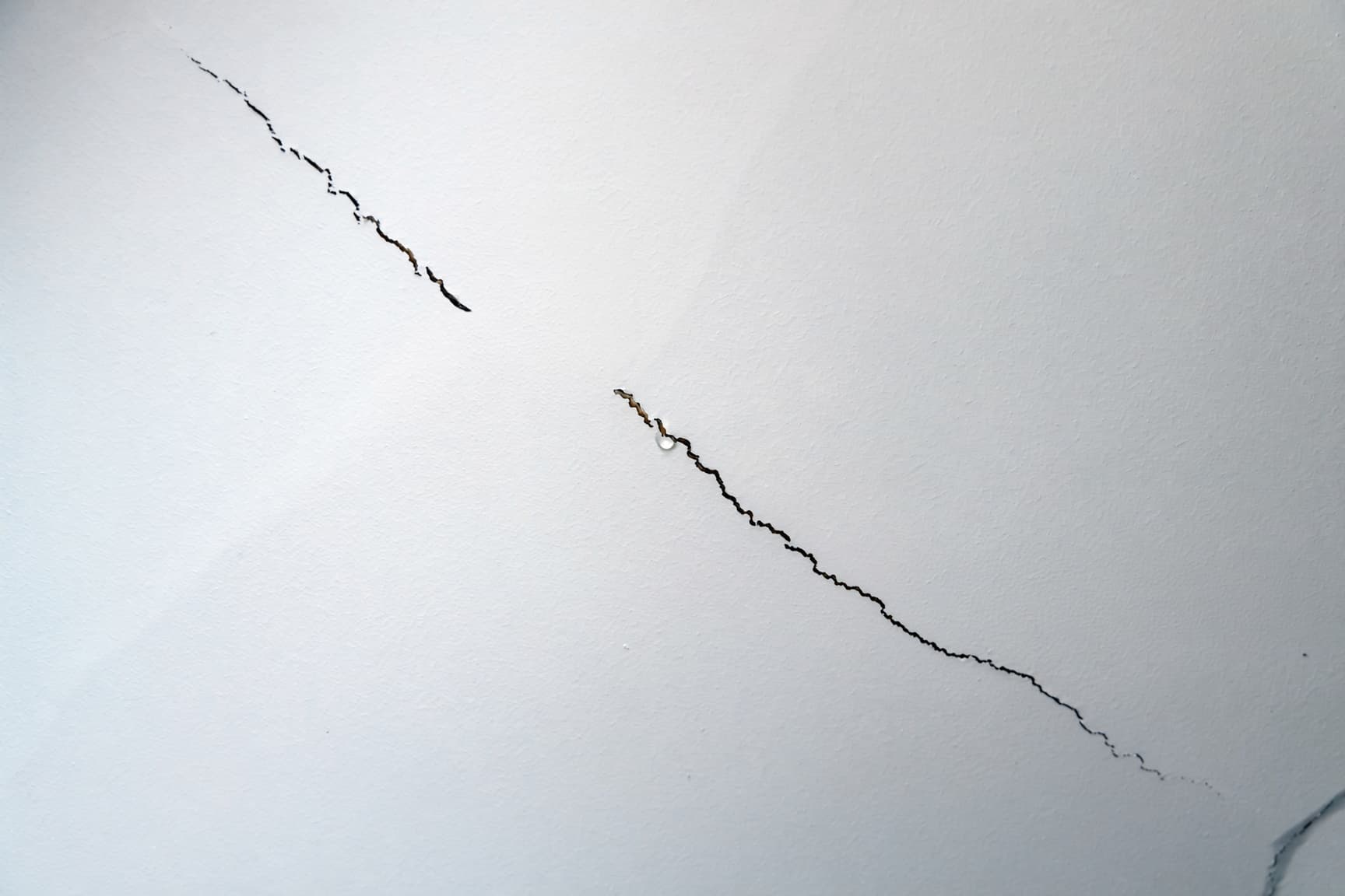 Long crack running along a drywall ceiling seam in a Colorado Springs home