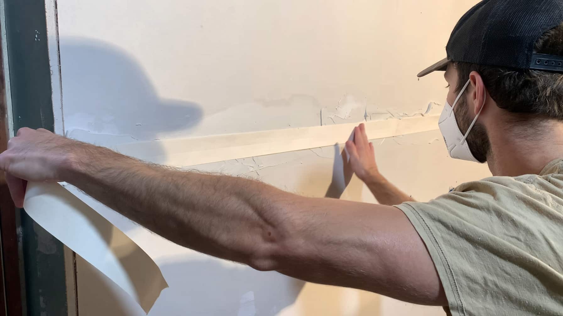 Drywall finishers taping a basement a homeowner hung in Colorado Springs