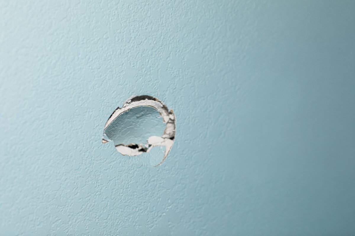 Repairing a doorknob hole in a Colorado Springs home's drywall
