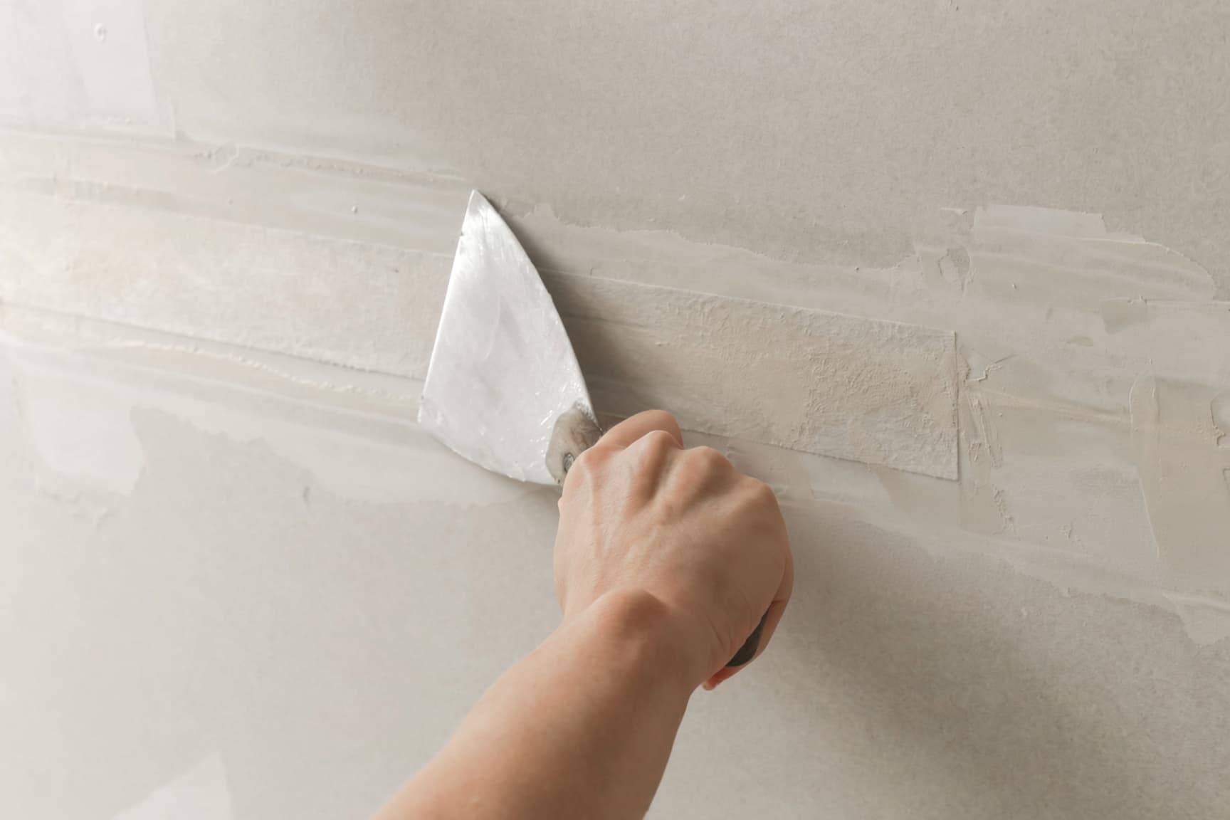 Taping and mudding drywall seams with joint compound in a Colorado Springs home