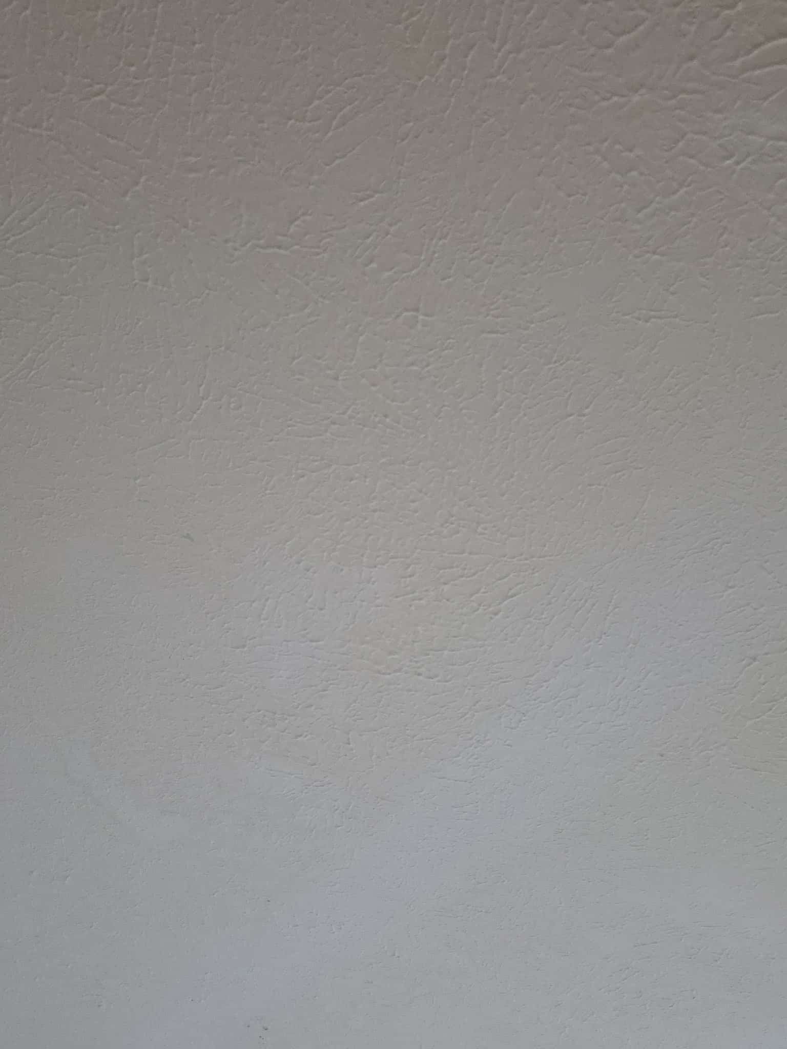 Smooth Level 5 drywall finish in a Colorado Springs living room with large windows
