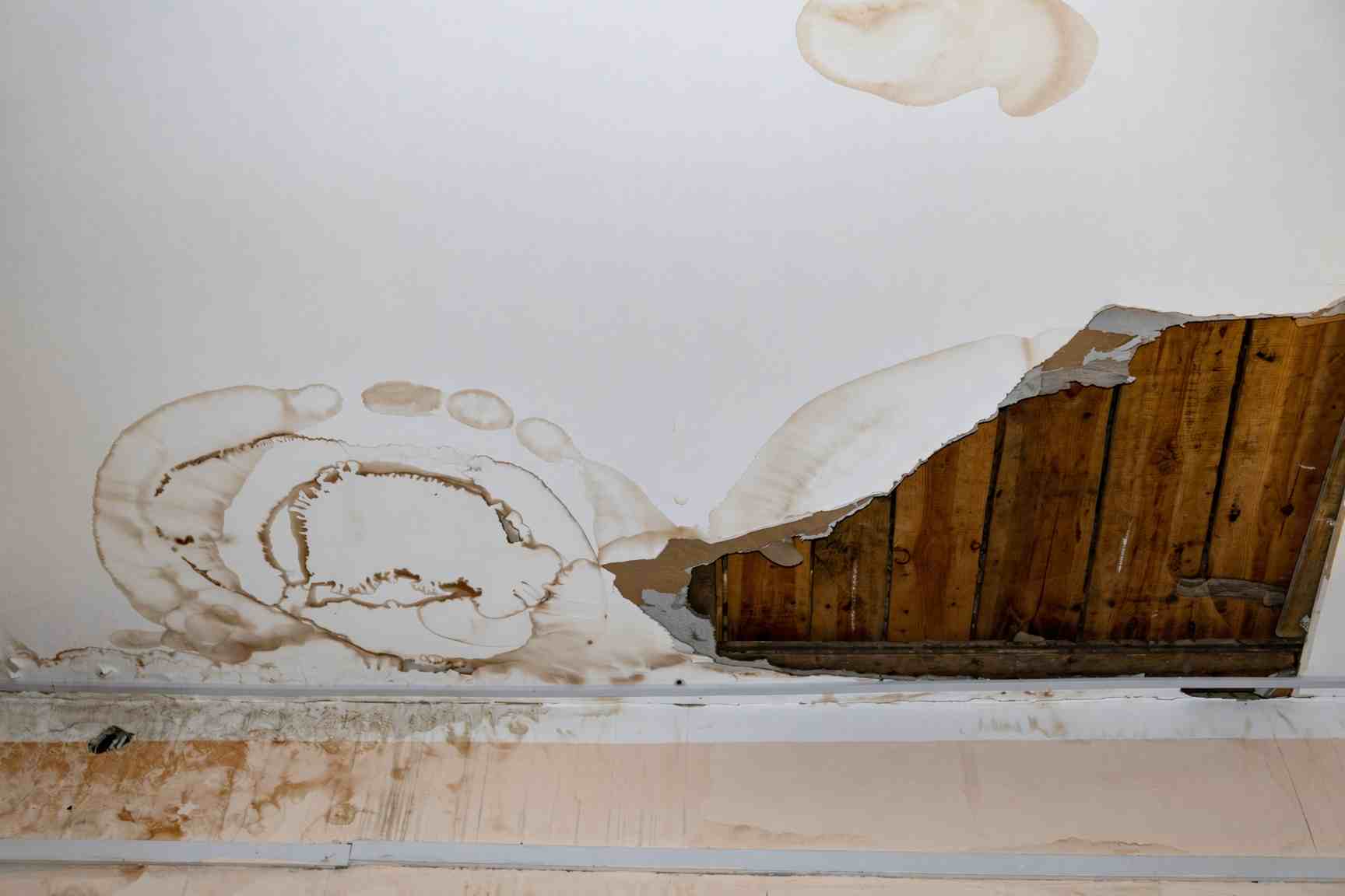 Water damaged ceiling drywall cut out after a hail roof leak in Colorado Springs
